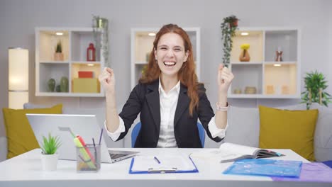 Home-office-worker-woman-experiencing-joy-looking-at-camera.